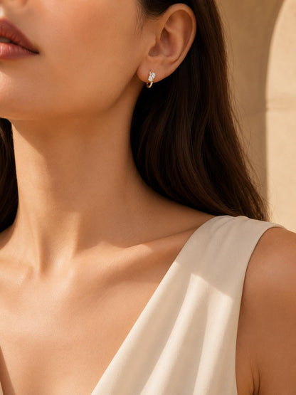 Model wearing 9mm 18K gold diamond cluster huggie earrings