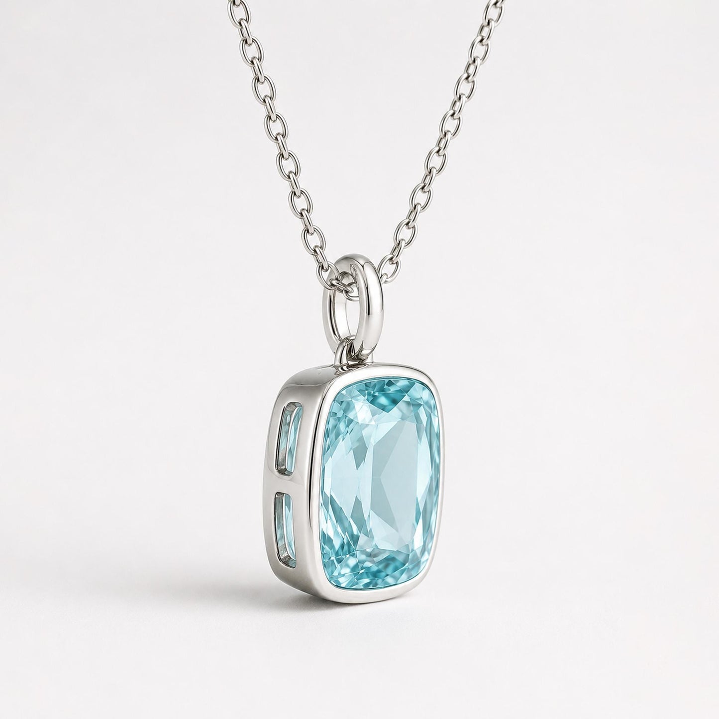 Side angle of blue topaz pendant setting and plain platinum oval bail