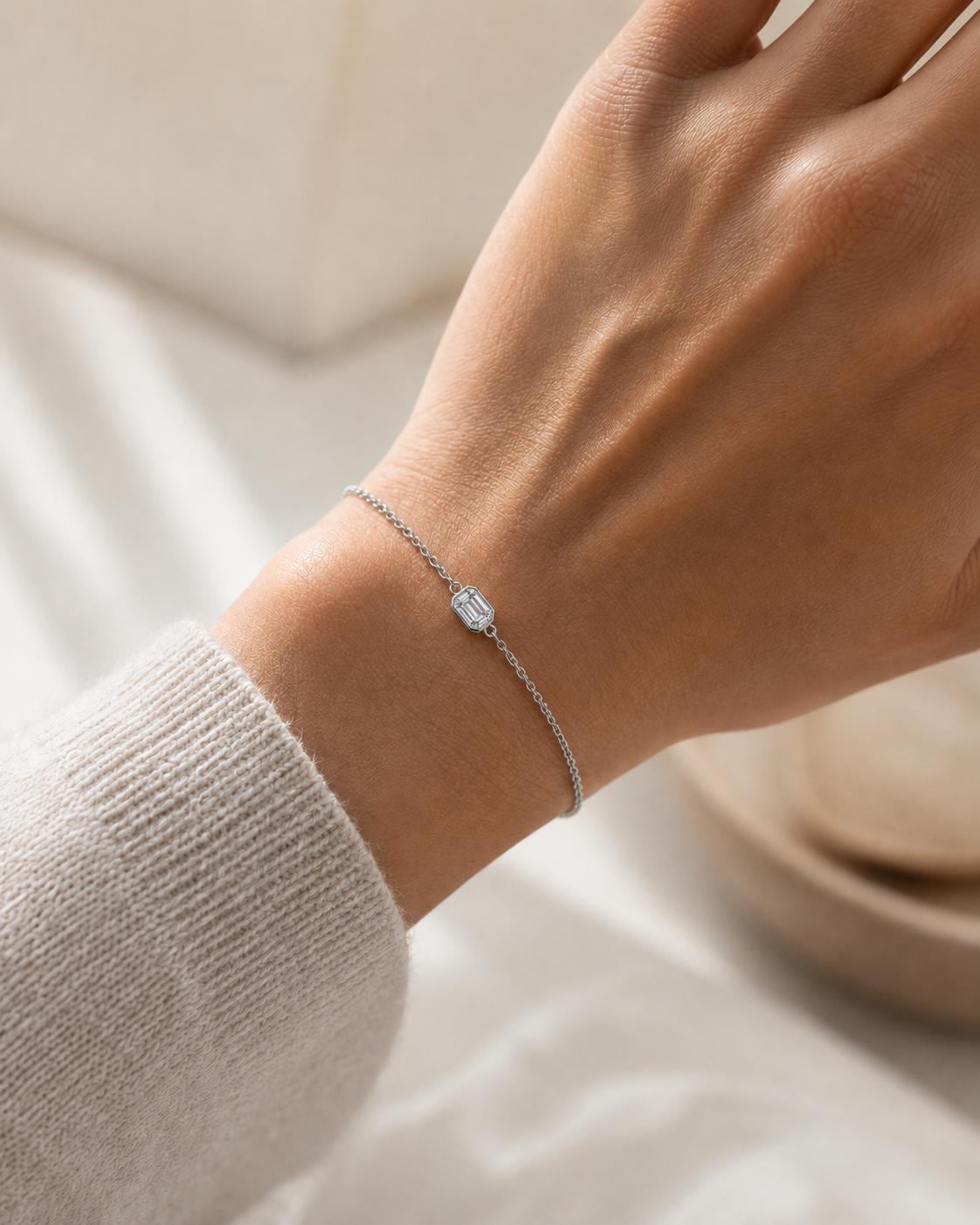 Close wrist view of bezel-set emerald lab diamond bracelet