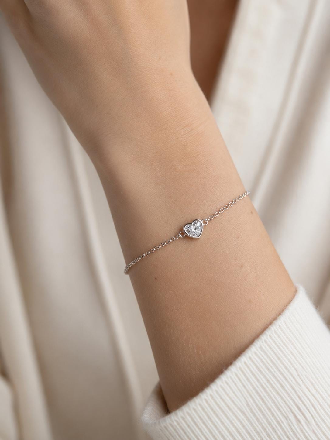 Woman wearing platinum heart lab diamond bracelet