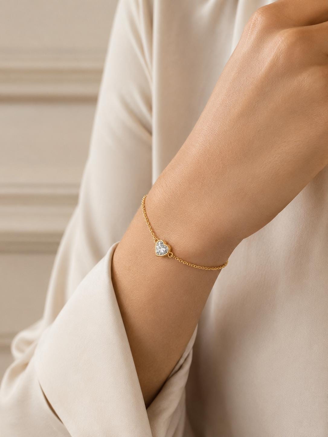 Woman wearing 18K yellow gold heart diamond bracelet