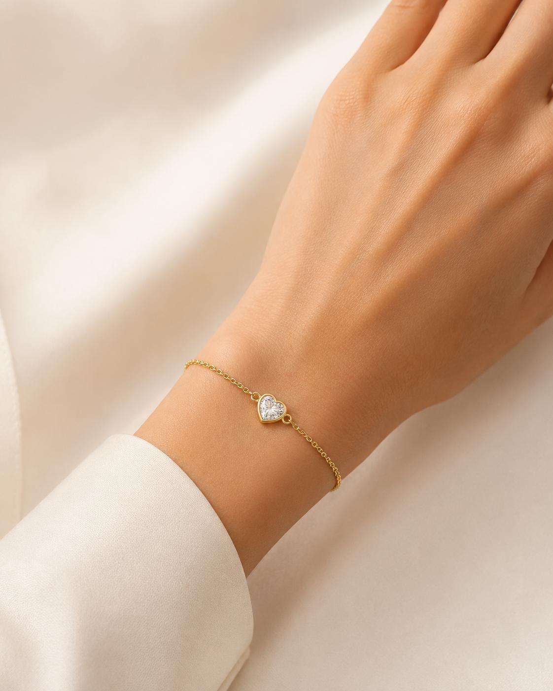 Woman wearing 18K gold heart lab diamond bracelet