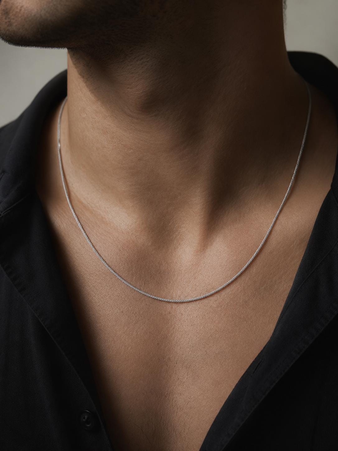 Man wearing polished PT950 platinum wheat chain with black shirt