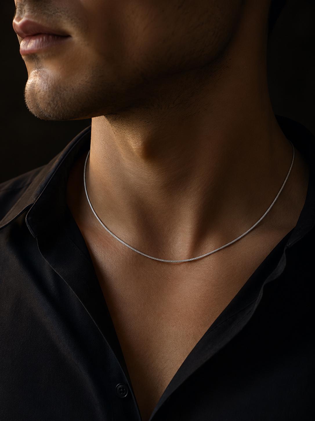 Man wearing solid platinum wheat chain necklace with black shirt