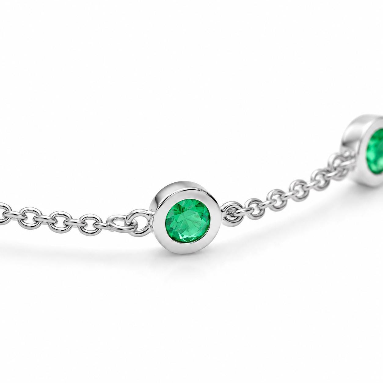 Macro view of bezel-set natural emerald in platinum