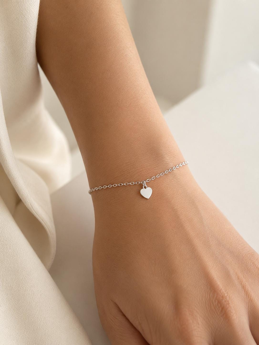 Close wrist view of PT950 heart charm bracelet