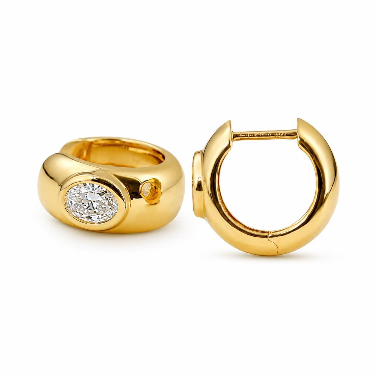 Side and front views of bezel-set oval diamond huggie hoops