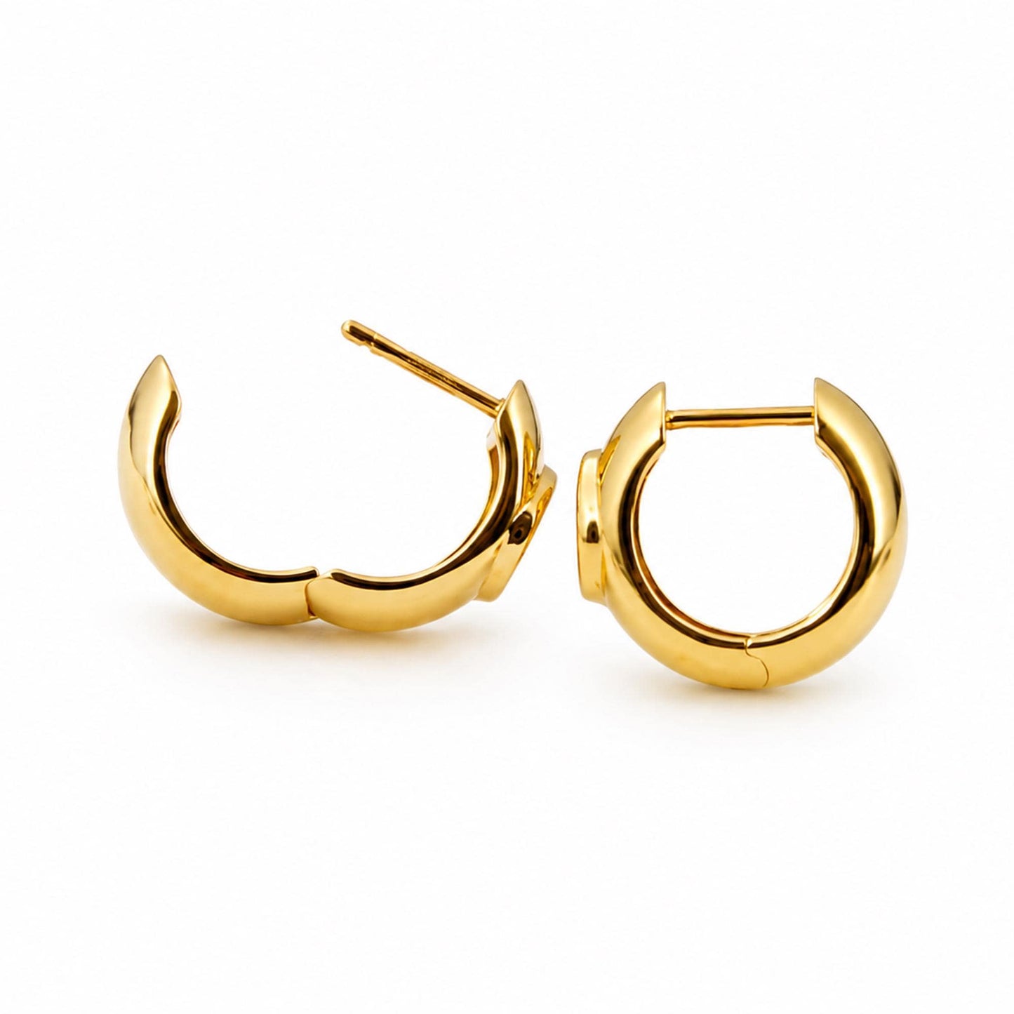 Open 18K gold oval diamond huggie hoops showing hinged closure
