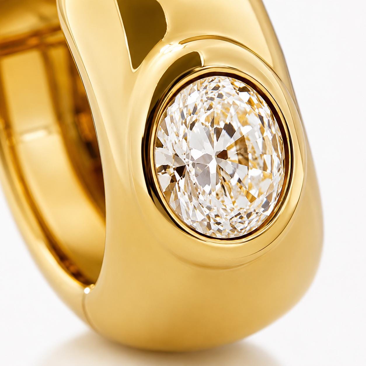 Macro view of oval lab diamond in an 18K gold bezel setting