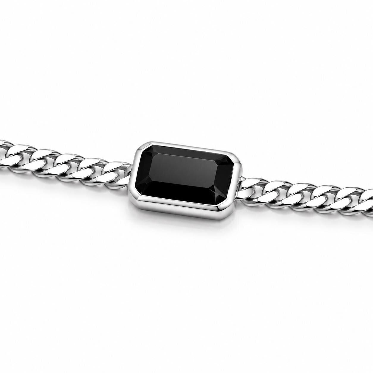 Macro detail of polished rectangular black onyx in platinum setting