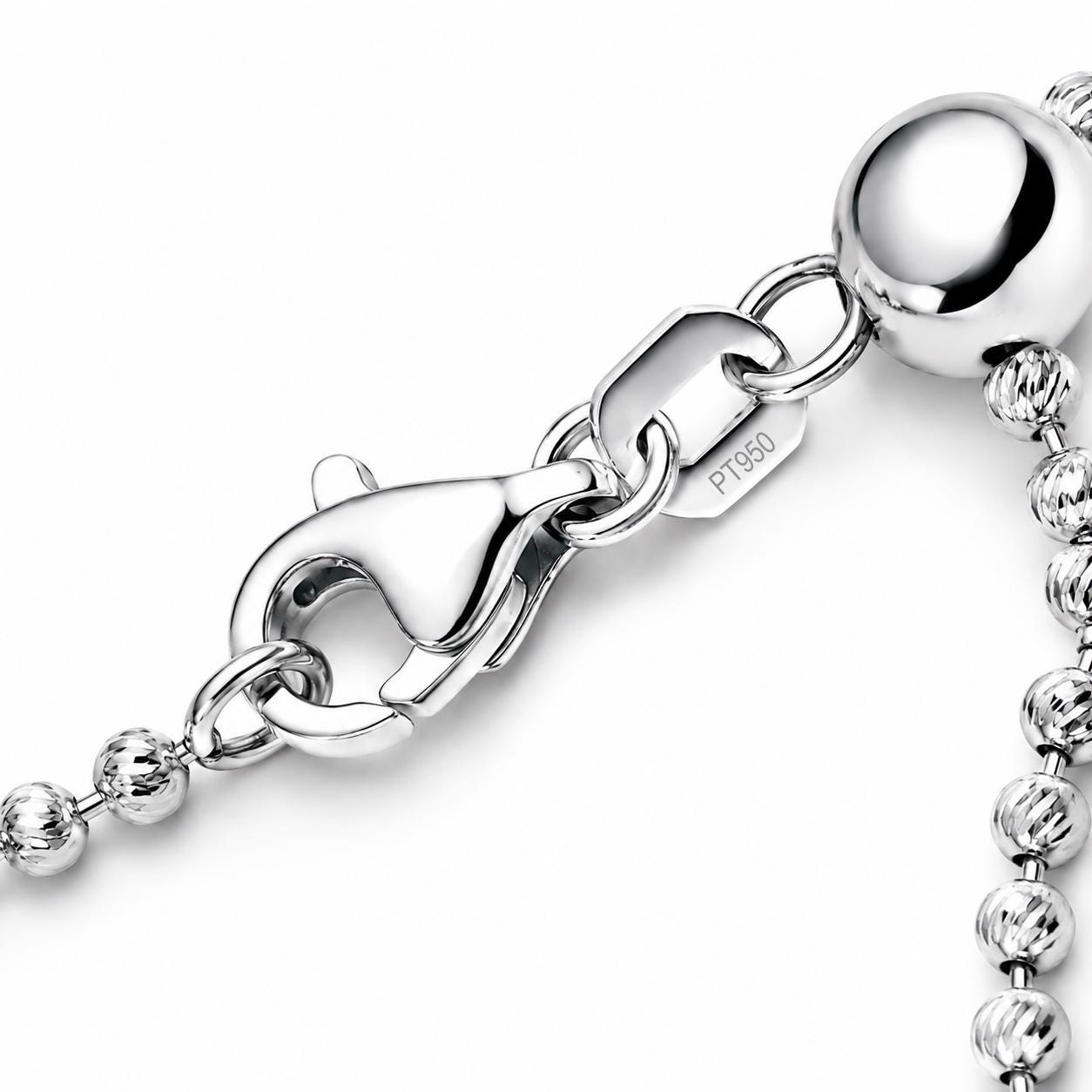 Close-up of platinum lobster clasp, PT950 tag and faceted bead chain
