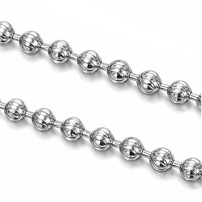 Macro detail of 1.5mm diamond-cut platinum beads with faceted surfaces