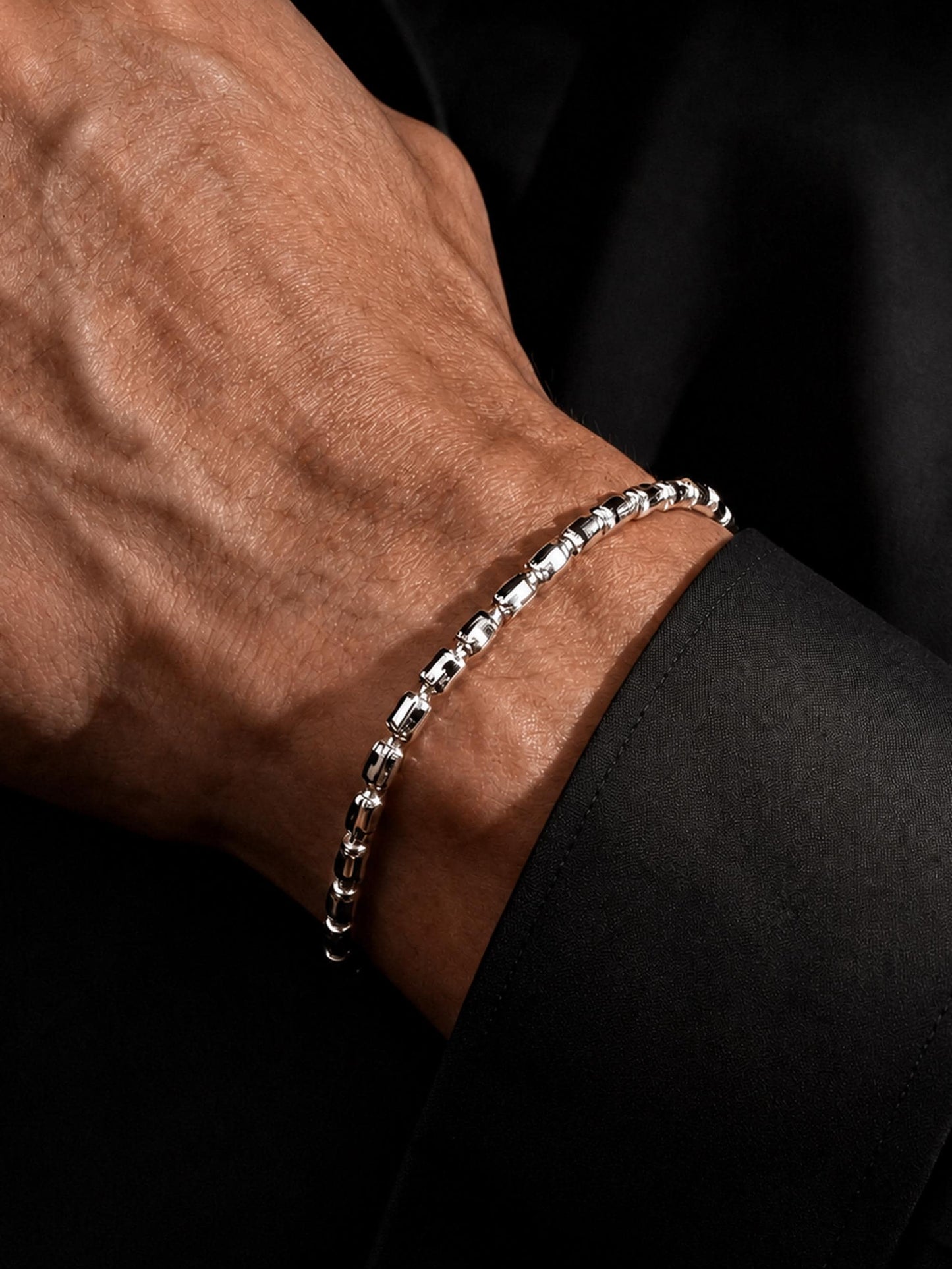 Close wrist view of solid platinum barrel link bracelet