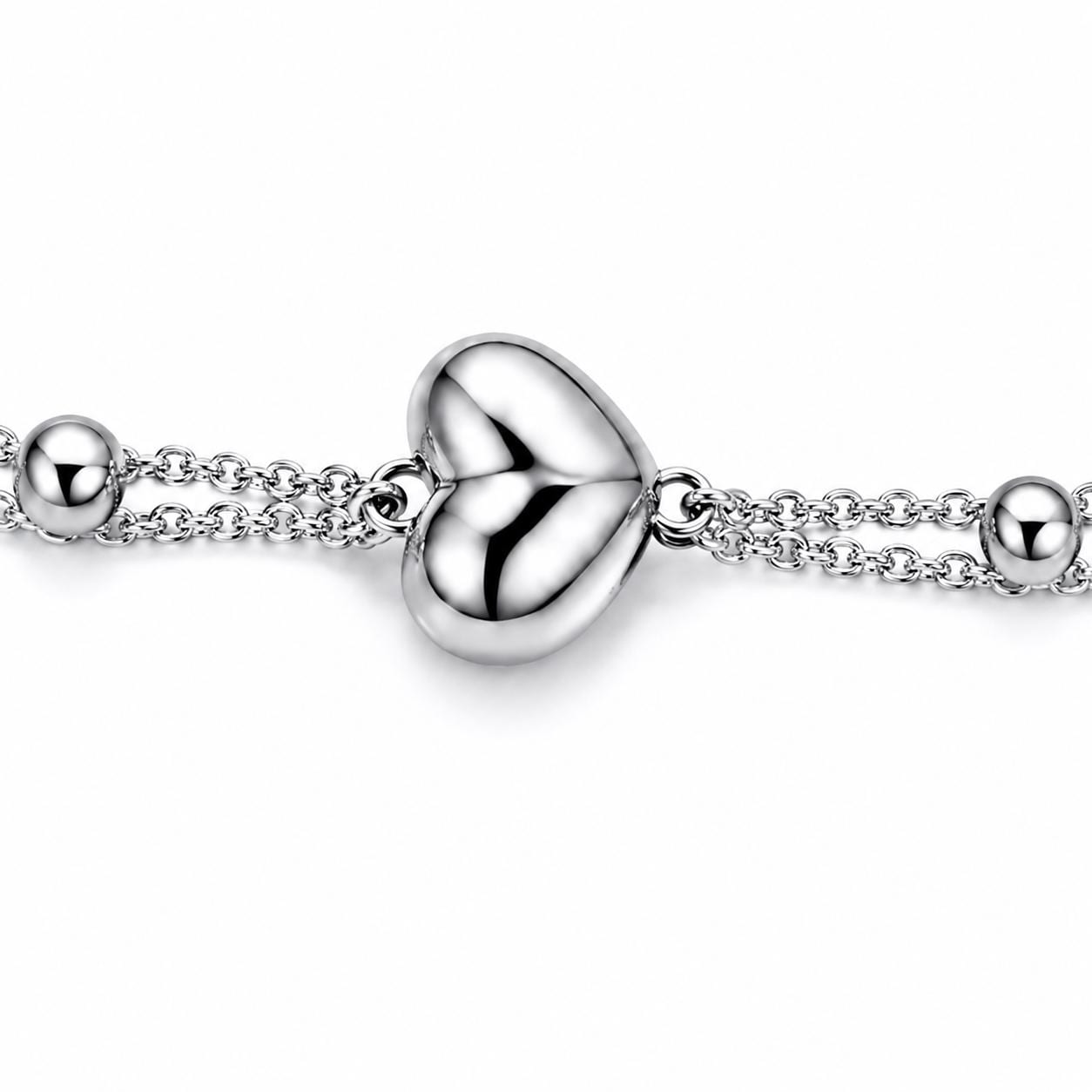Macro detail of polished platinum heart and bead accents