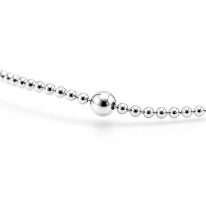 Macro detail of polished 2.4mm platinum station bead and bead chain