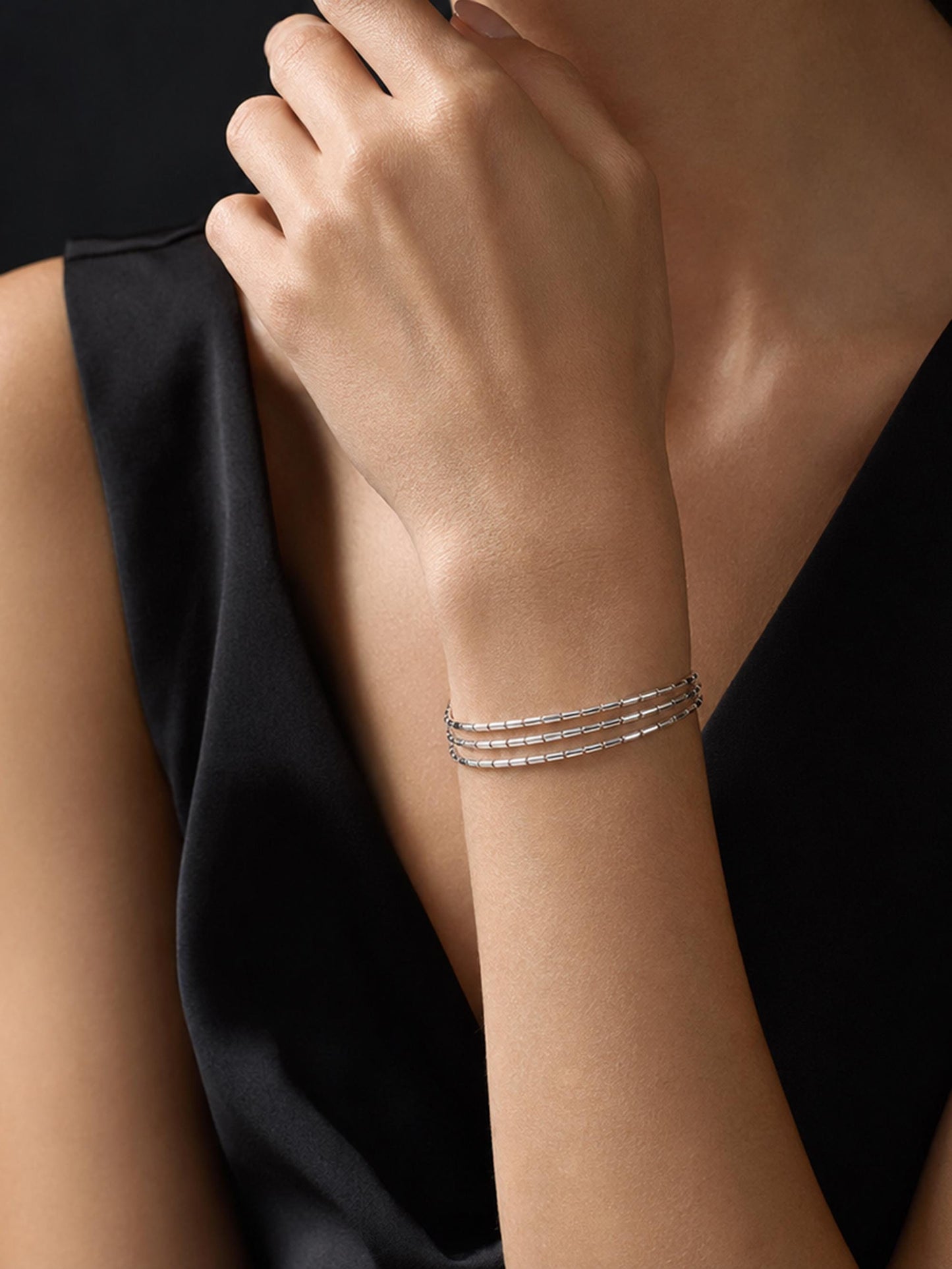 Close wrist view of PT950 three-strand bracelet