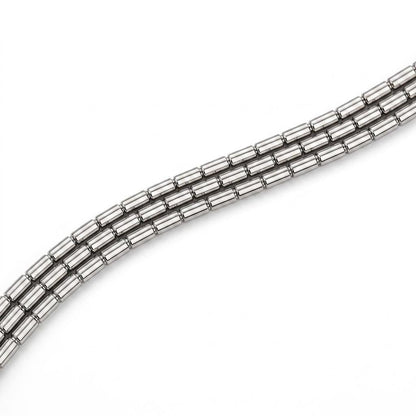Macro detail of three faceted platinum chain strands