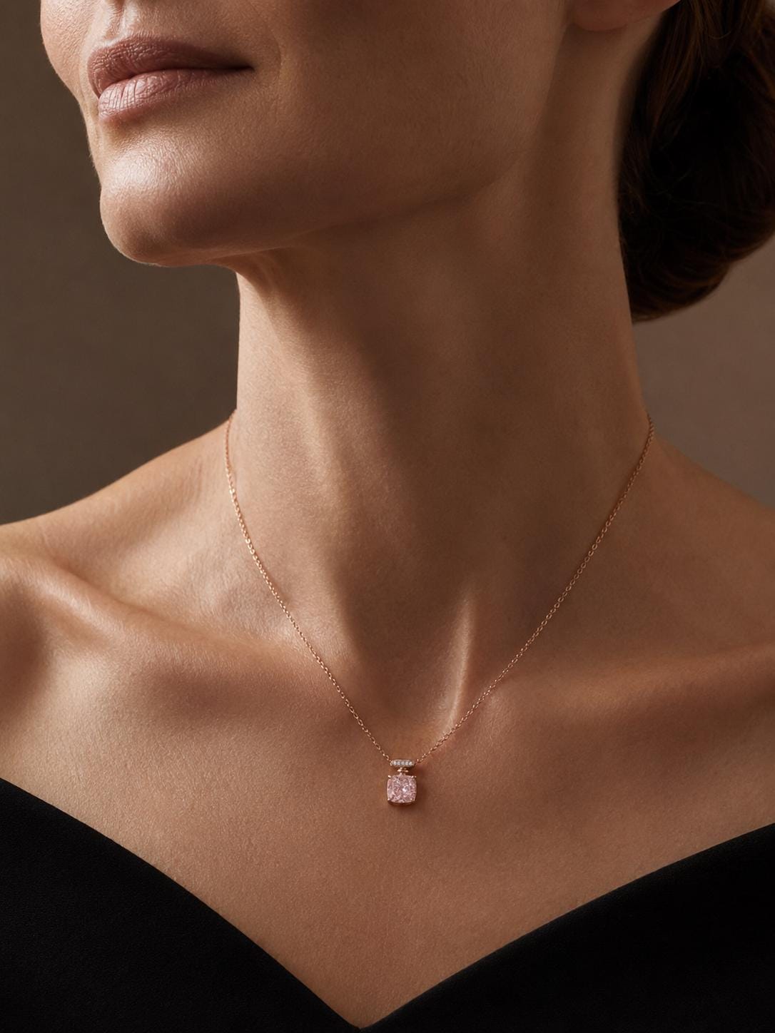 Woman wearing pink lab-grown diamond necklace with black off-shoulder dress