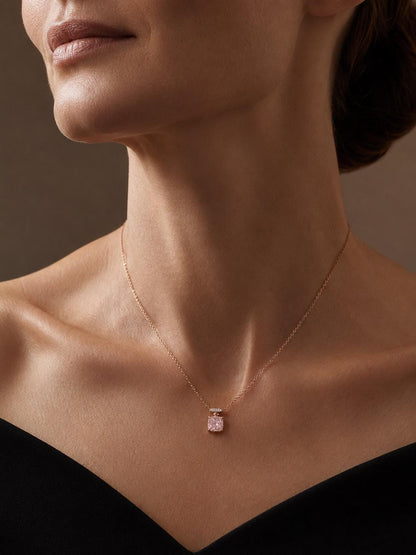 Woman wearing pink lab-grown diamond necklace with black off-shoulder dress