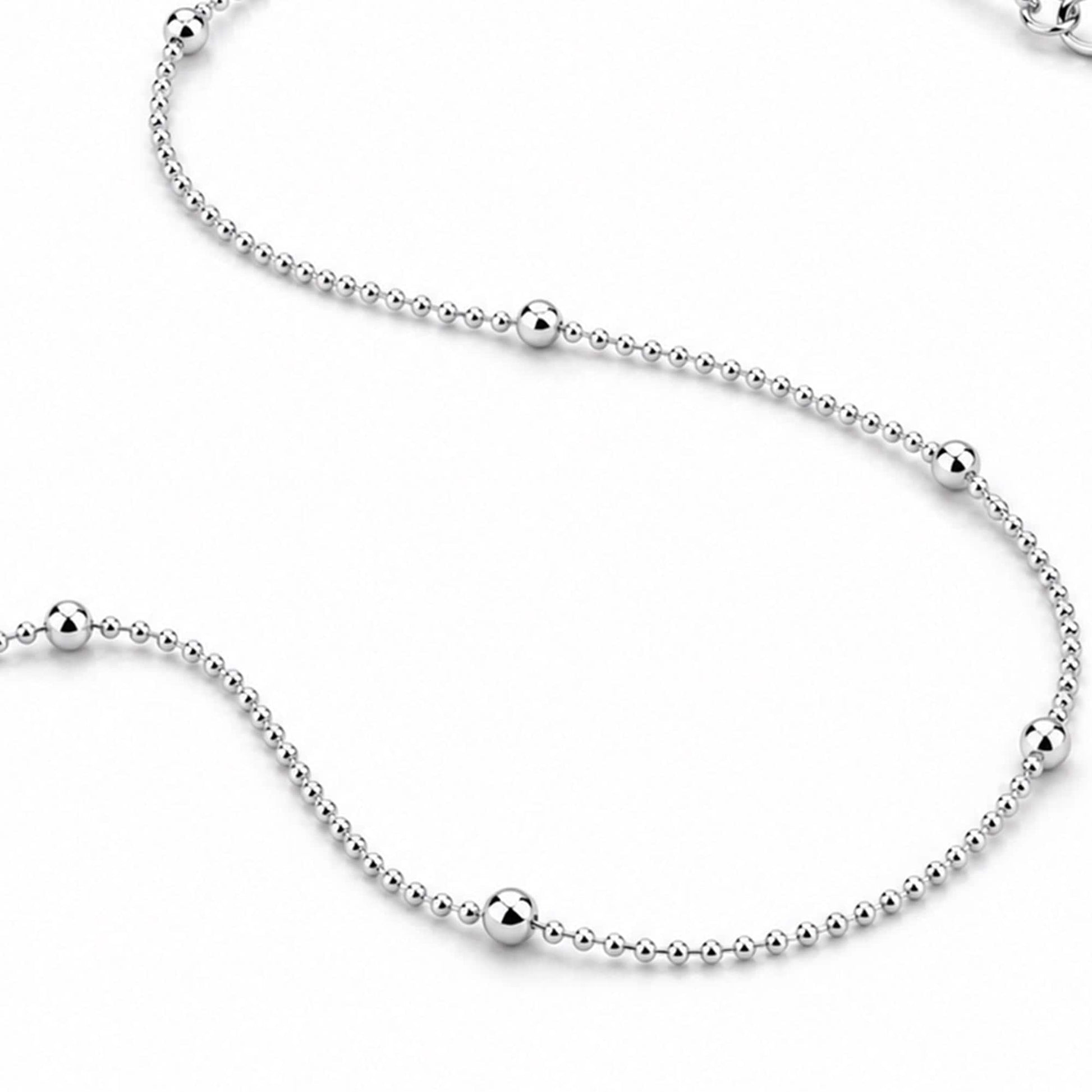 Curved PT950 platinum station necklace showing bead spacing and finish
