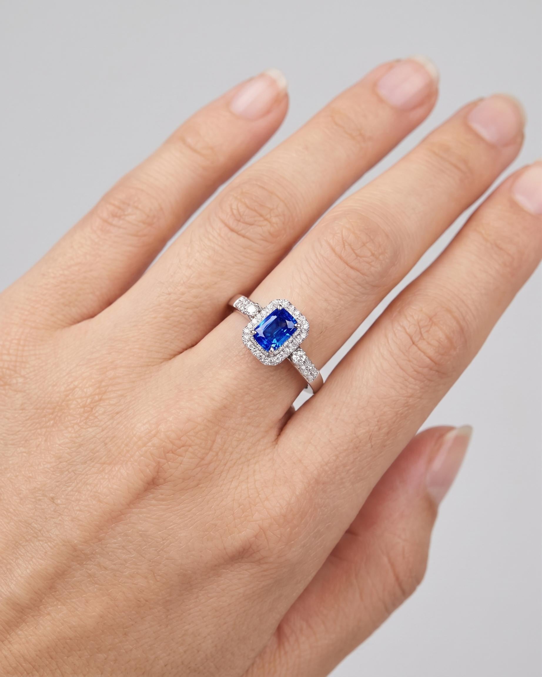 Royal blue sapphire halo ring worn view