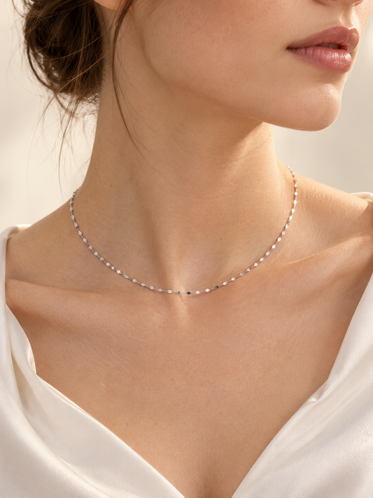 Lustre delicate 1.5mm platinum necklace worn with an ivory blouse