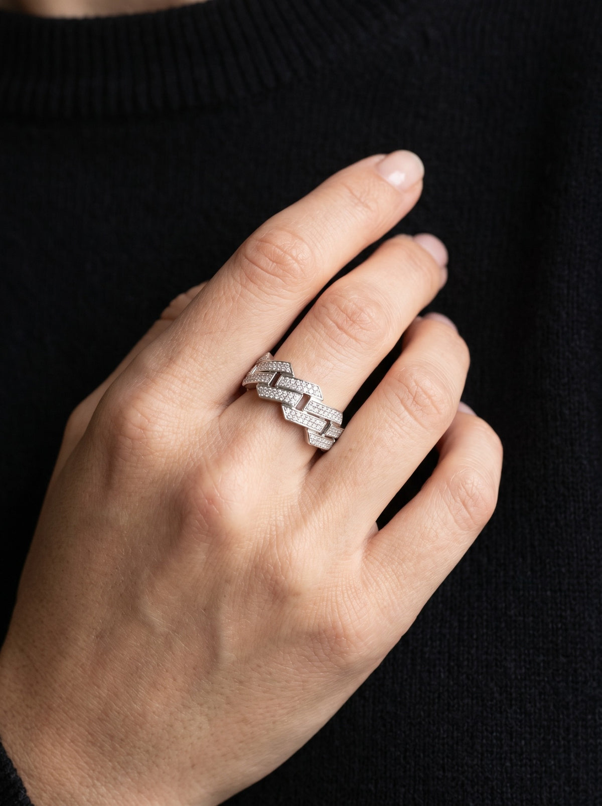 Nexus platinum lab-grown diamond ring worn against black knitwear.